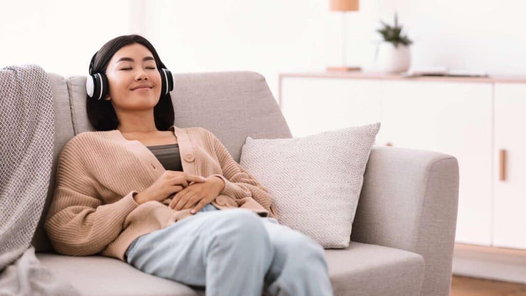  Music Therapy in Mental Health Treatment Woman With Headphones on Couch