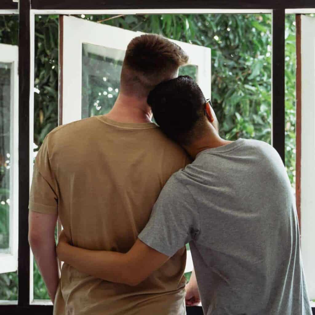  Couple-Hugging-Staring-out-Window-LGBTQIA-Addiction-Treatmentjpg