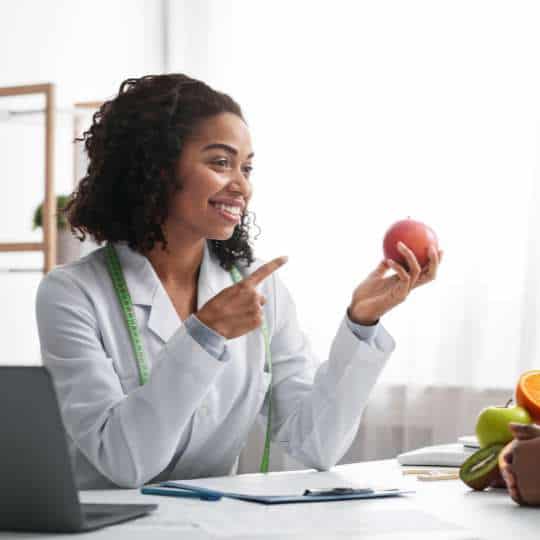   Eating Disorder Treatment Modalities Nutritionist Pointing To An Apple